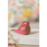 Glassfigur fugl i rosa på dekorbok