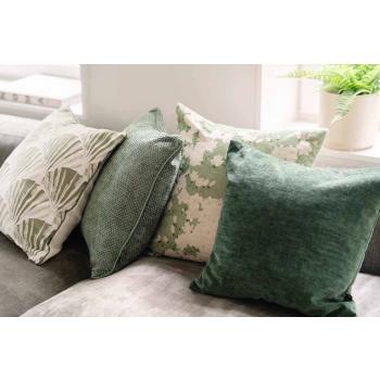 Putetrekk med ulike grønn toner liggende i sofa