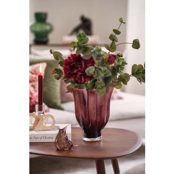 Stilkblomst Peon og gren eucalyptus i burgunder vase